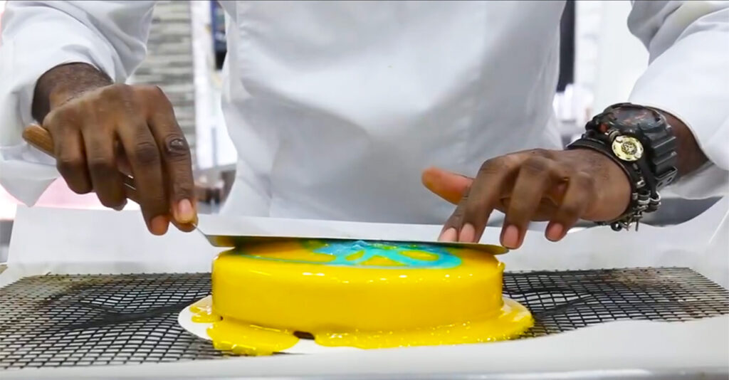 Pastry Chef Anthony Smith glazing mirror cake image